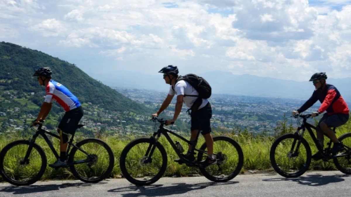 Group Mountain biking on a scenic hill route near Kathmandu Valley, Nepal