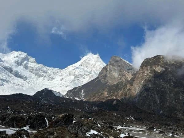 Ancient Buddhist chortens and mani walls in Tsum Valley, Nepal with Himalayan mountain views.