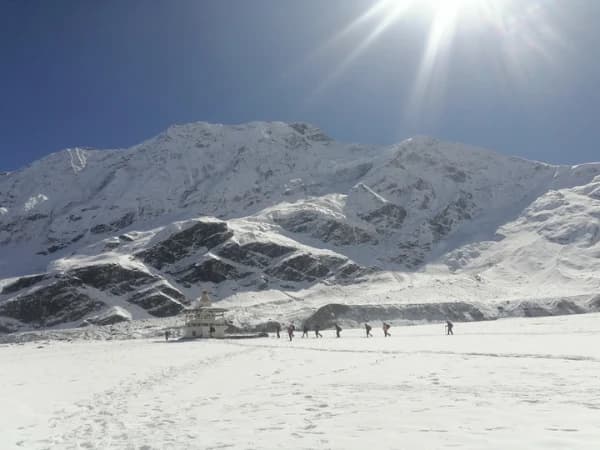 Ancient Buddhist chortens and mani walls in Tsum Valley, Nepal with Himalayan mountain views.